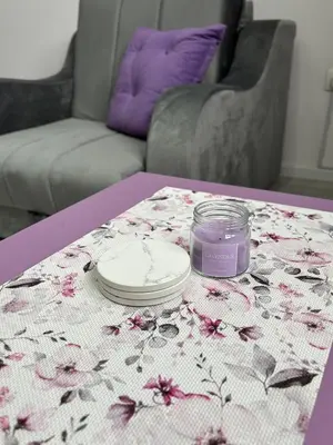 a table with a table cloth with a candle on it at Apartman LILLY in Paraćin