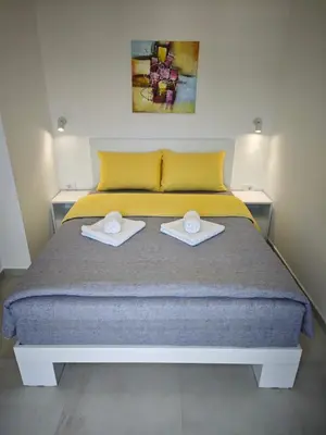 a bedroom with a bed with two towels on it at Apartmani Čokić Sokobanja in Soko Banja