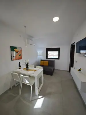 a living room with a white table and a couch at Apartmani Čokić Sokobanja in Soko Banja