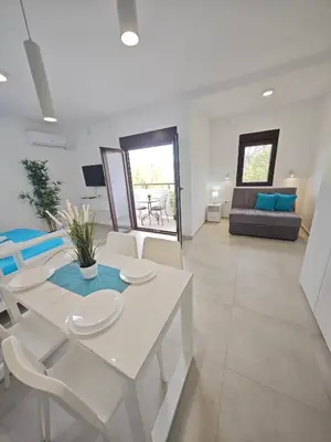 a living room with a white table and chairs at Apartmani Čokić Sokobanja in Soko Banja