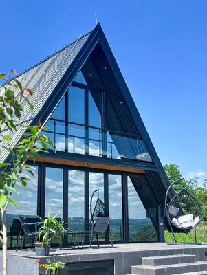 a house with a roof that has glass at Kod Lutajuceg in Despotovac