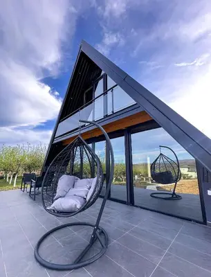 a swing on the roof of a house at Kod Lutajuceg in Despotovac