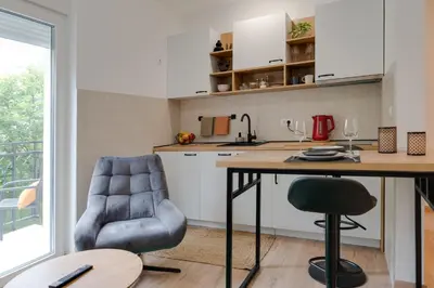 a kitchen with a counter and a table and chairs at Vila Dara in Vrnjačka Banja