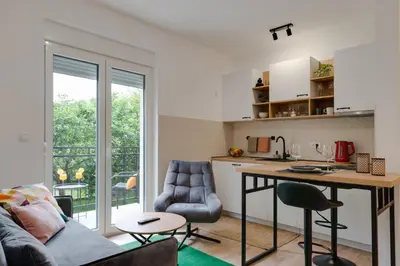 a kitchen and living room with a couch and a table at Vila Dara in Vrnjačka Banja