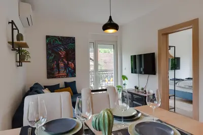 a dining room with a table with wine glasses at Vila Dara in Vrnjačka Banja