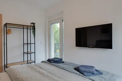 a bedroom with a bed and a television on a wall at Vila Dara in Vrnjačka Banja