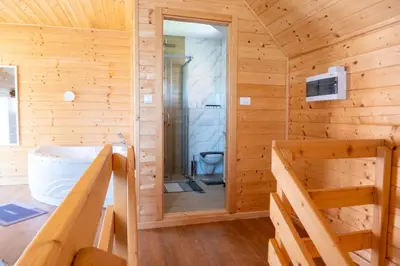 a wooden cabin with a shower and a toilet at Brvnare Janković in Goč
