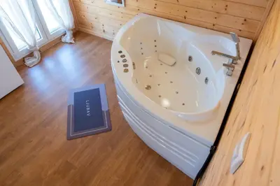 a book sitting on the floor next to a bath tub at Brvnare Janković in Goč