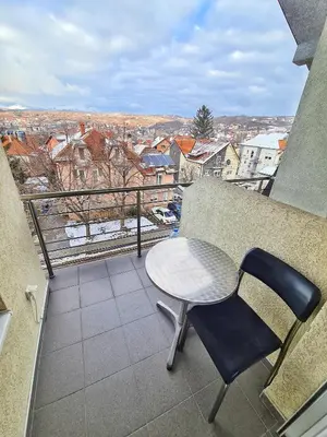 a table and chairs on a balcony with a view at Vila Aleksandra 2 Studio 13 in Soko Banja