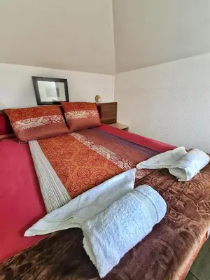 a bedroom with a large bed with pillows on it at Vila Aleksandra 2 Studio 13 in Soko Banja