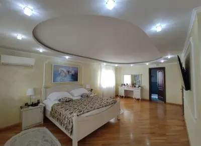 a bedroom with a large bed and a round ceiling at Village House Gracac in Ðurovići