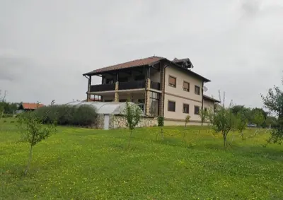 a large house in the middle of a field at Village House Gracac in Ðurovići