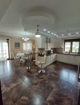 a large kitchen and dining room with a table and chairs at Village House Gracac in Ðurovići