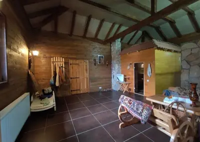 a large room with wooden walls and a table at Village House Gracac in Ðurovići