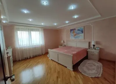 a bedroom with a large bed and a wooden floor at Village House Gracac in Ðurovići
