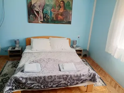 a bedroom with a bed with two towels on it at BoHan sobe Vladičin Han in Vladičin Han