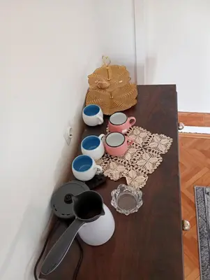 a wooden table with bowls and utensils on it at BoHan sobe Vladičin Han in Vladičin Han