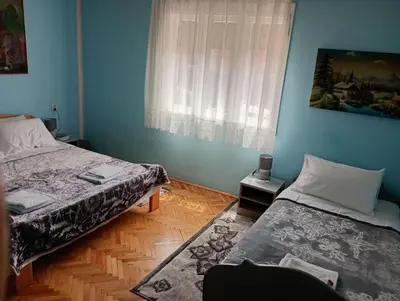 a bedroom with two beds and a window at BoHan sobe Vladičin Han in Vladičin Han