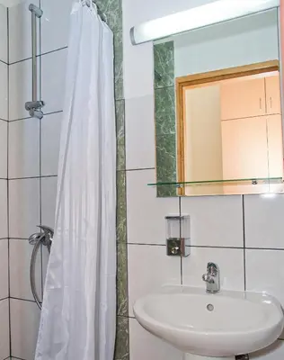 a bathroom with a sink and a mirror at Garni hotel Alma in Pirot