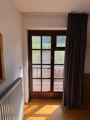 a room with a large door with a window at Lisine Ribnjak in Despotovac