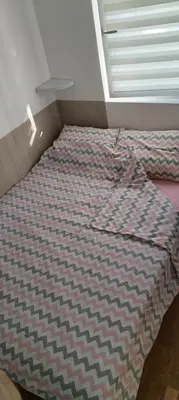 an unmade bed in a room with a window at Mila in Soko Banja