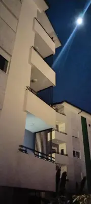 a building with balconies on the side of it at night at Mila in Soko Banja