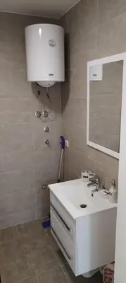 a bathroom with a white sink and a mirror at Mila in Soko Banja