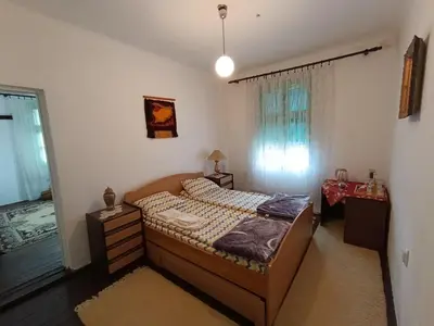 a bedroom with a bed and a window at Vila Jagoda in Bojnik