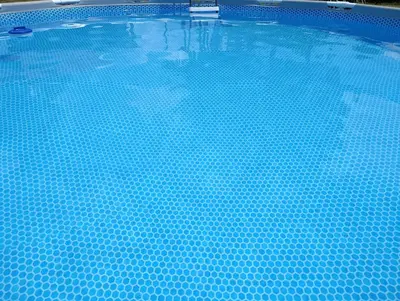 a swimming pool with blue tiles on the water at Vila Jagoda in Bojnik