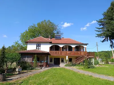a large house with a porch and a deck at Vila Jagoda in Bojnik