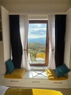 a bedroom with a window with a view at Apartman The Nest in Kopaonik