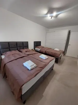 a bedroom with two beds with towels on them at Brand new apartment in the city center in Niš