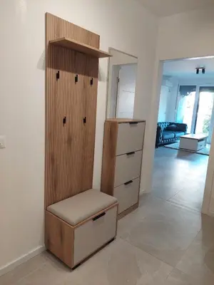 a room with a cabinet and a chair in it at Brand new apartment in the city center in Niš