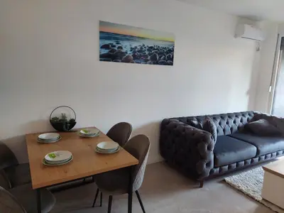 a living room with a couch and a table at Brand new apartment in the city center in Niš