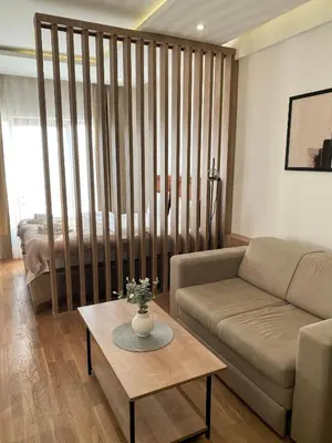 a living room with a couch and a table at NLux Nest Milmari in Kopaonik