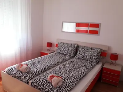 a bedroom with a bed with two slippers on it at River lux in Bukorovac
