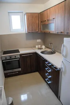 a small kitchen with a sink and a refrigerator at River lux in Bukorovac