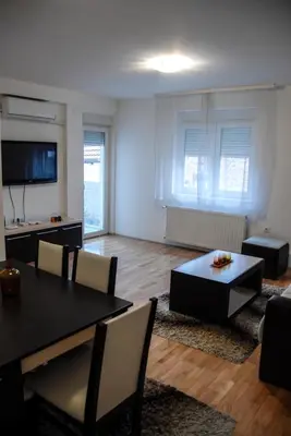 a living room with a black table and chairs and a couch at River lux in Bukorovac