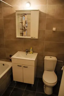a bathroom with a toilet and a sink and a mirror at River lux in Bukorovac