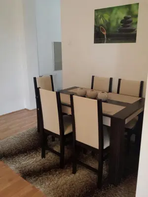 a dining room table and chairs in a room at River lux in Bukorovac
