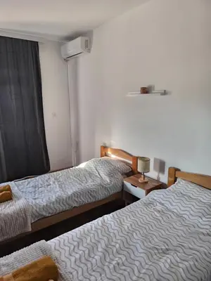 a hotel room with two beds and a window at Apartmani Dana in Vranje
