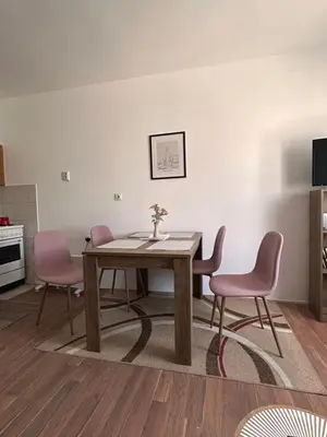 a dining room with a table and two chairs at Apartmani Dana in Vranje