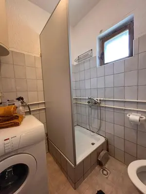 a bathroom with a washing machine and a sink at Apartmani Dana in Vranje