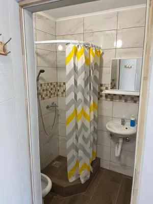 a bathroom with a shower curtain and a sink at Studio in Soko Banja