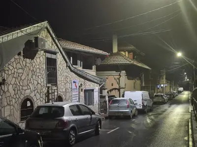 a group of cars parked on a street at night at Yugoslavija Lux 3 in Aleksandrovac