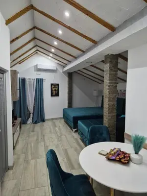 a living room with a table and a couch at Yugoslavija Lux 3 in Aleksandrovac