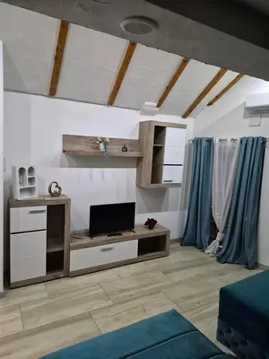 a living room with a flat screen tv on a cabinet at Yugoslavija Lux 3 in Aleksandrovac