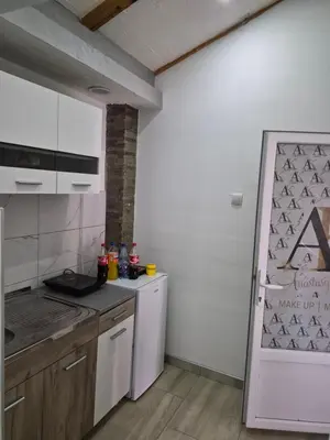 a kitchen with a white refrigerator and a stove at Yugoslavija Lux 3 in Aleksandrovac