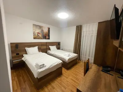 a hotel room with two beds and a television at Bici Resort in Samoljica
