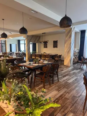 a dining room with wooden tables and chairs at Bici Resort in Samoljica